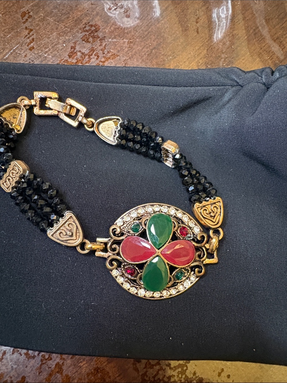 Gold-Tone Bracelet with Black Beads and Red & Green Gem Medallion